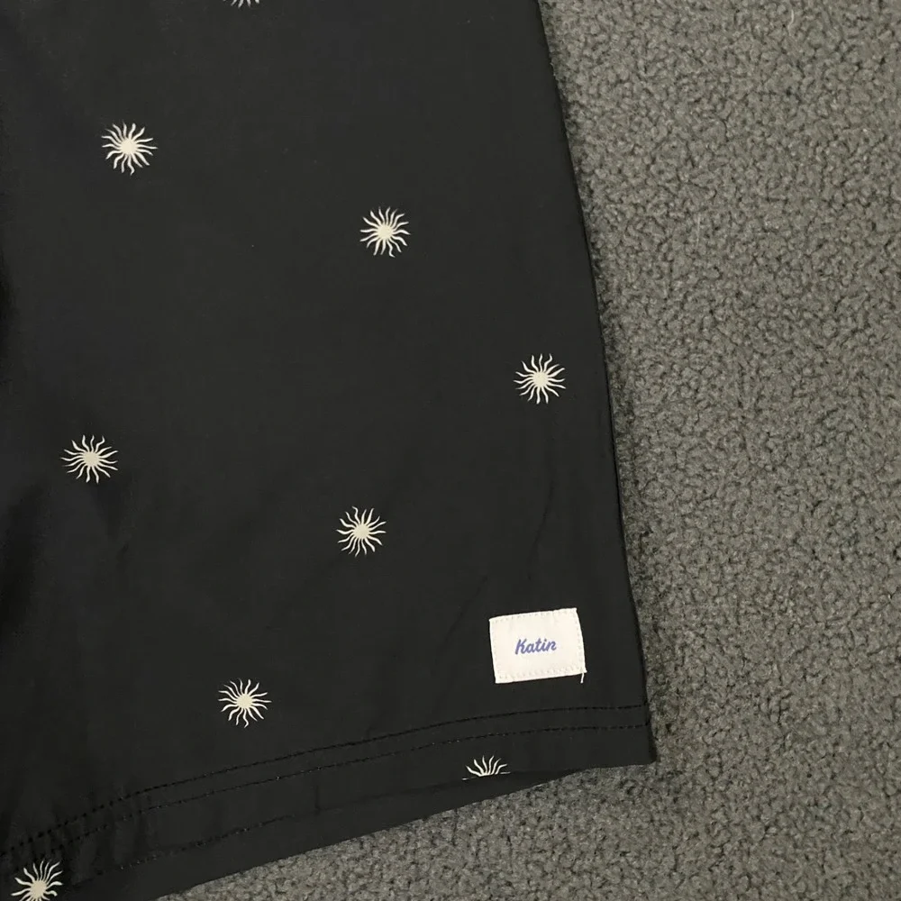 NWOT Katin Black Swim Hybrids with Light Blue Waistband & White Starburst Print